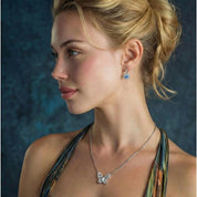 Sterling silver drop earrings featuring cushion-cut blue moissanite stones surrounded by sparkling halo settings